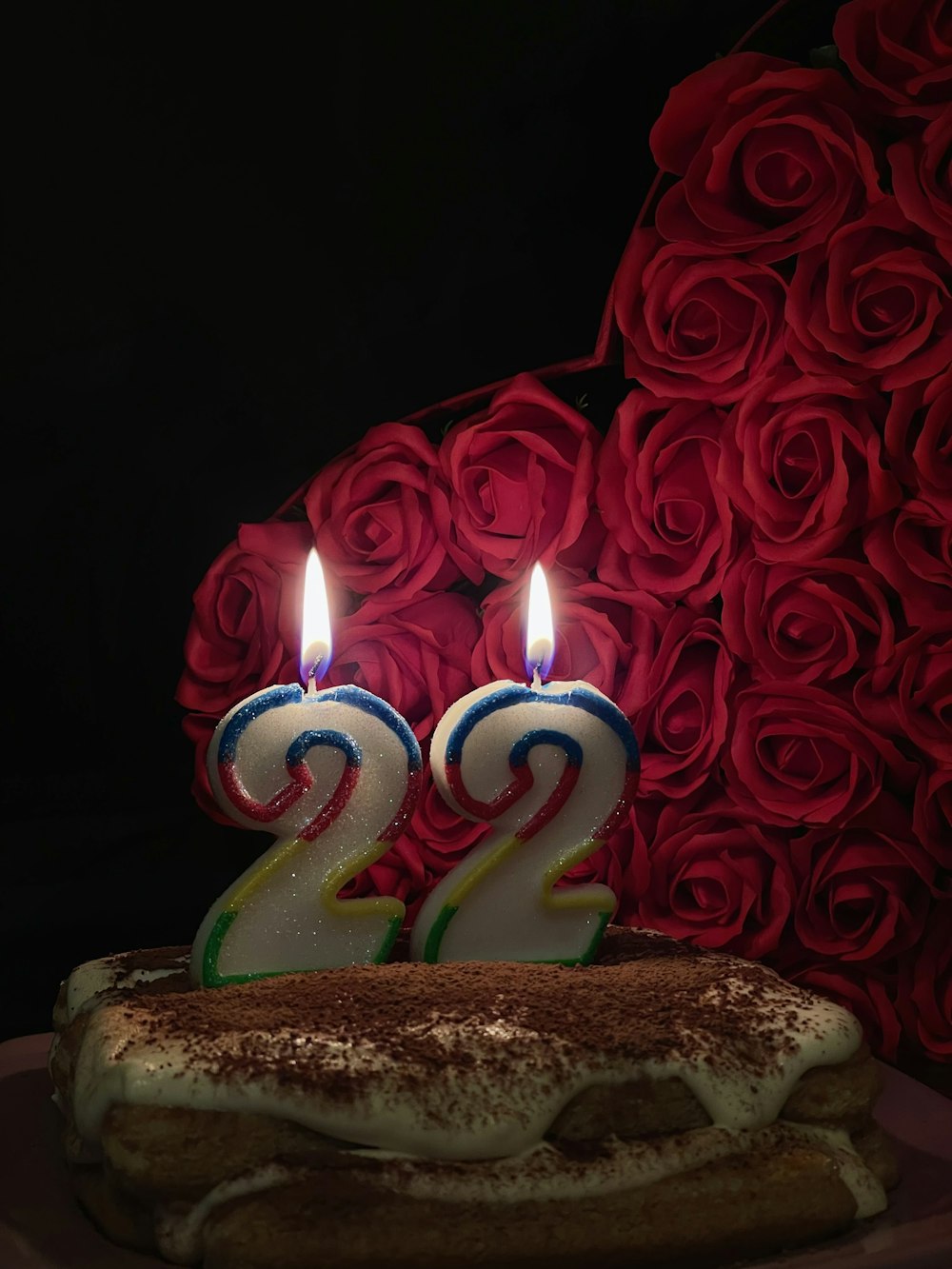a birthday cake with two candles on top of it
