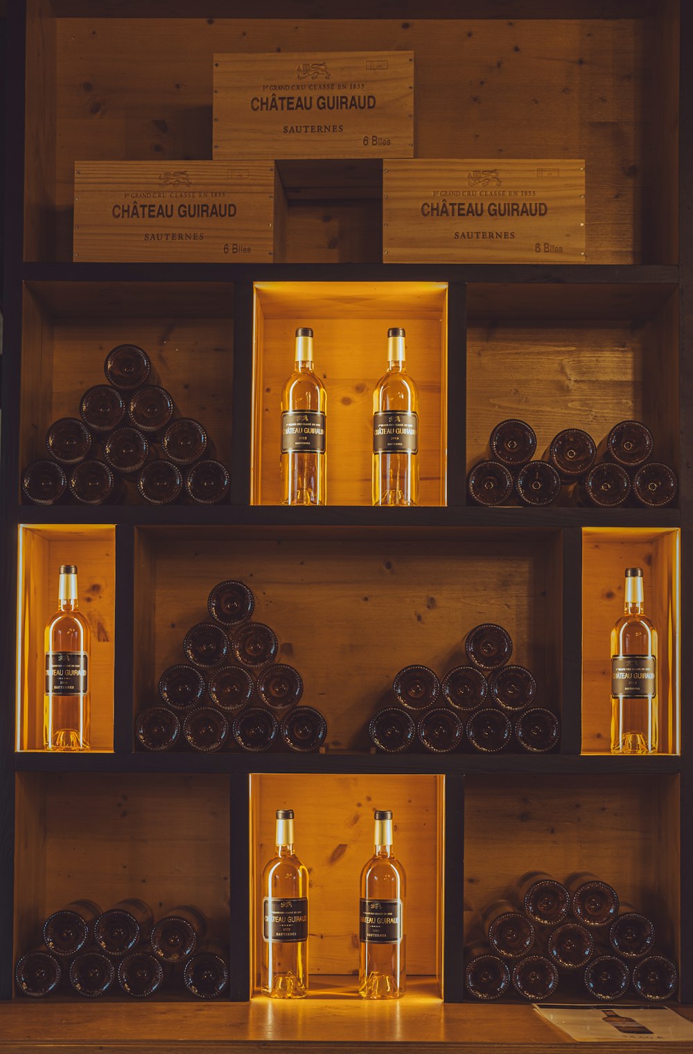 a wooden shelf filled with bottles of liquor