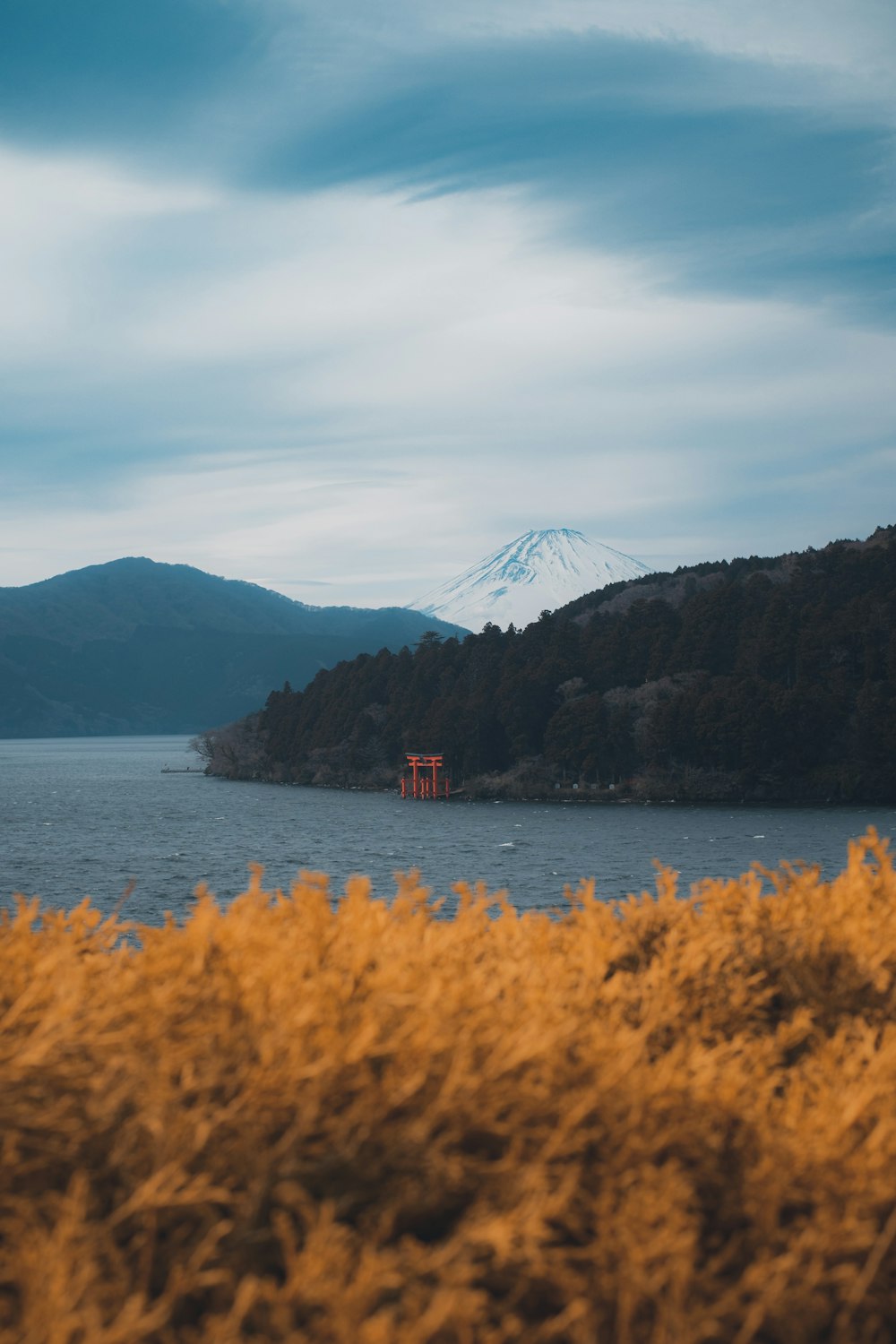 a body of water with a mountain in the background