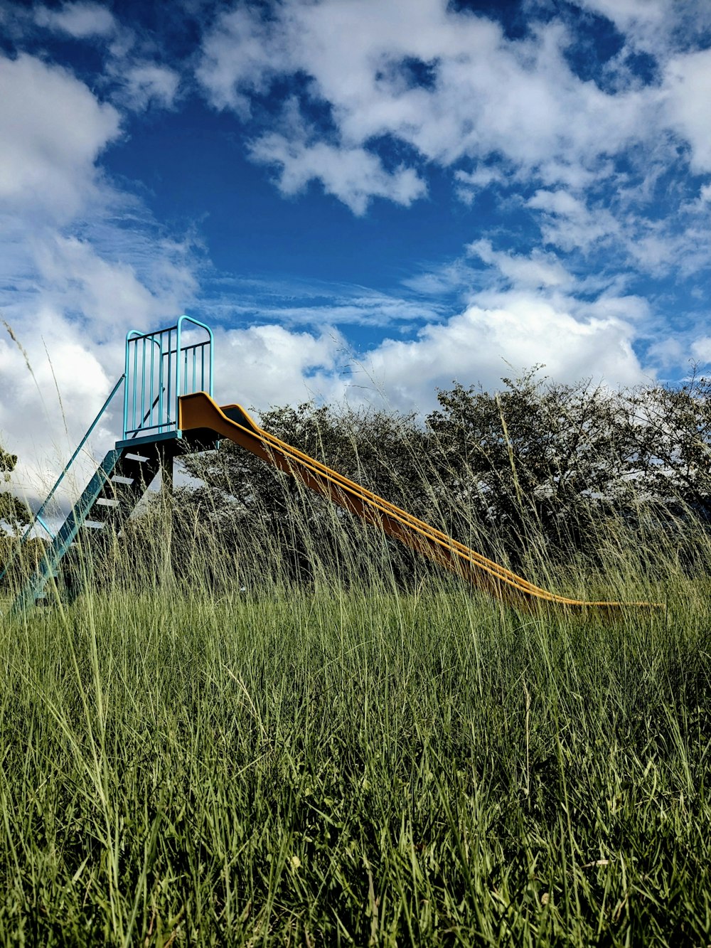 a slide in the middle of a grassy field