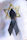 Close-up of a personalized funeral ribbon with elegant calligraphy on a dark green background