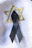 Close-up of a personalized funeral ribbon with elegant calligraphy on a dark green background