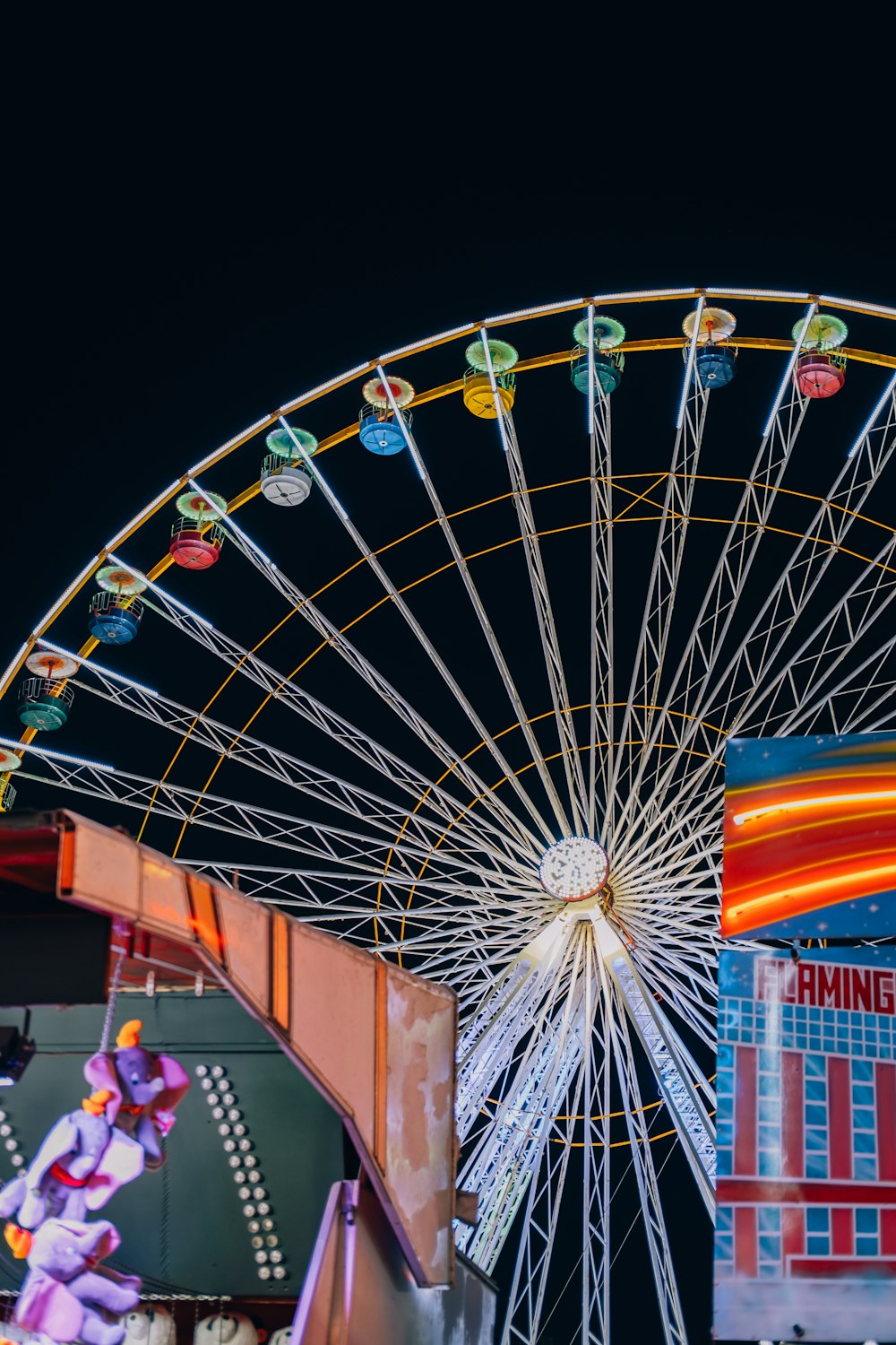 a ferris wheel is lit up at night