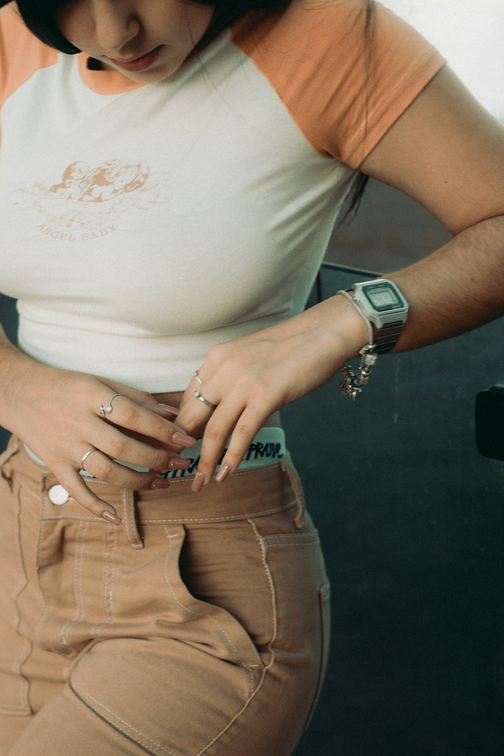 a woman wearing a white shirt and tan pants