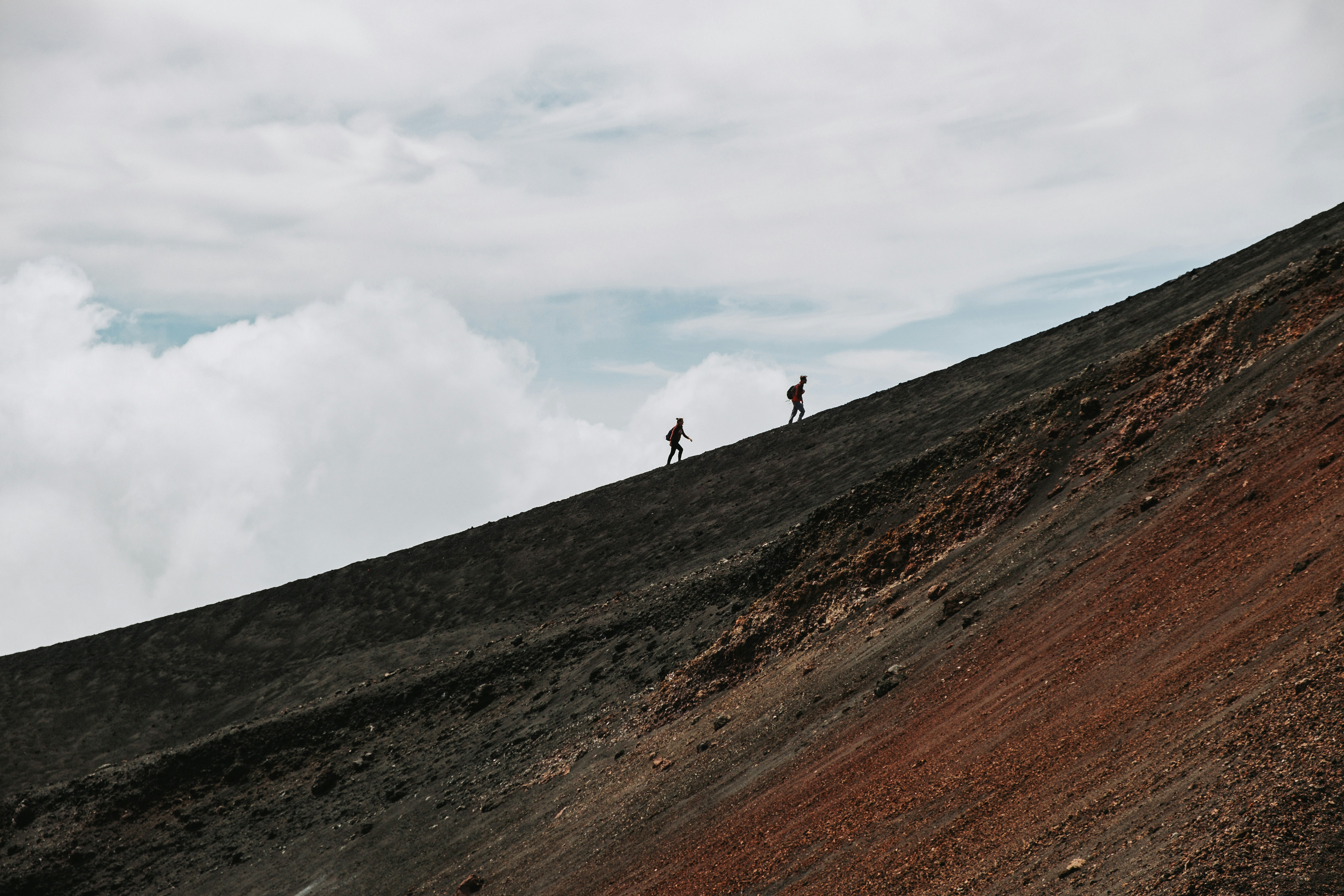 a couple of people standing on top of a hill