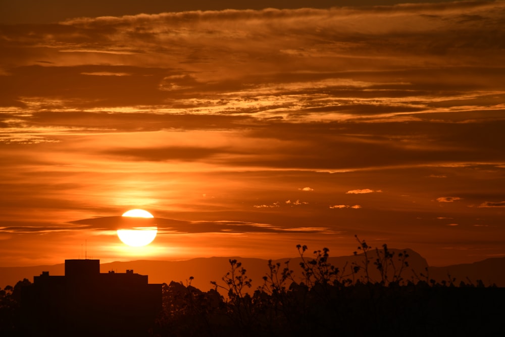 the sun is setting over a city skyline