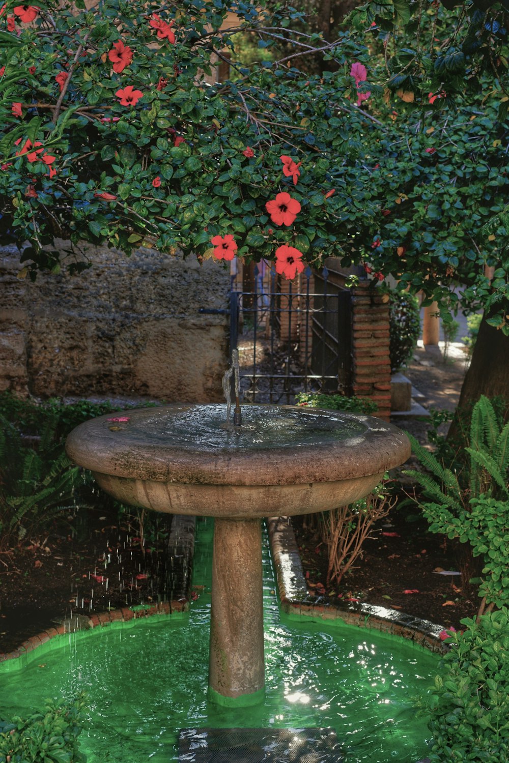 a fountain with flowers on top of it