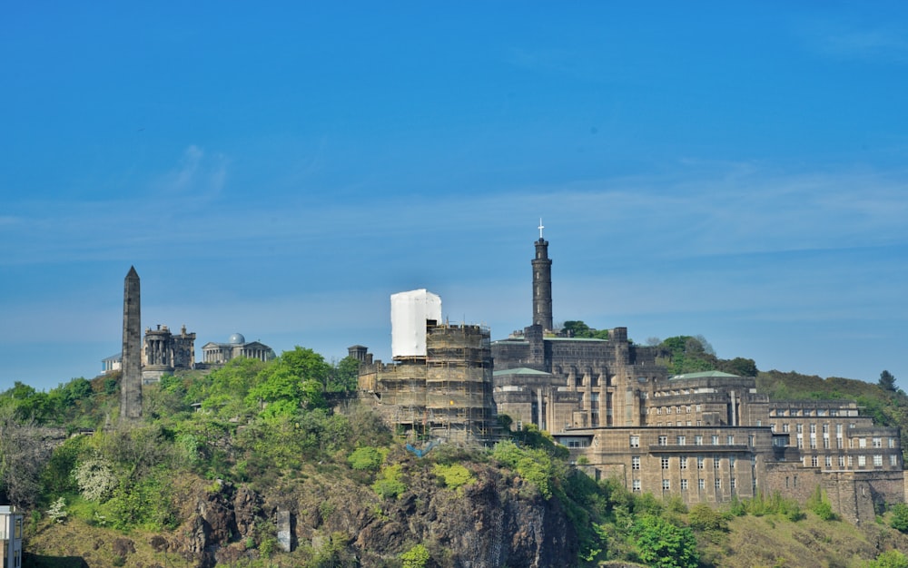 a large building on a hill with trees on it