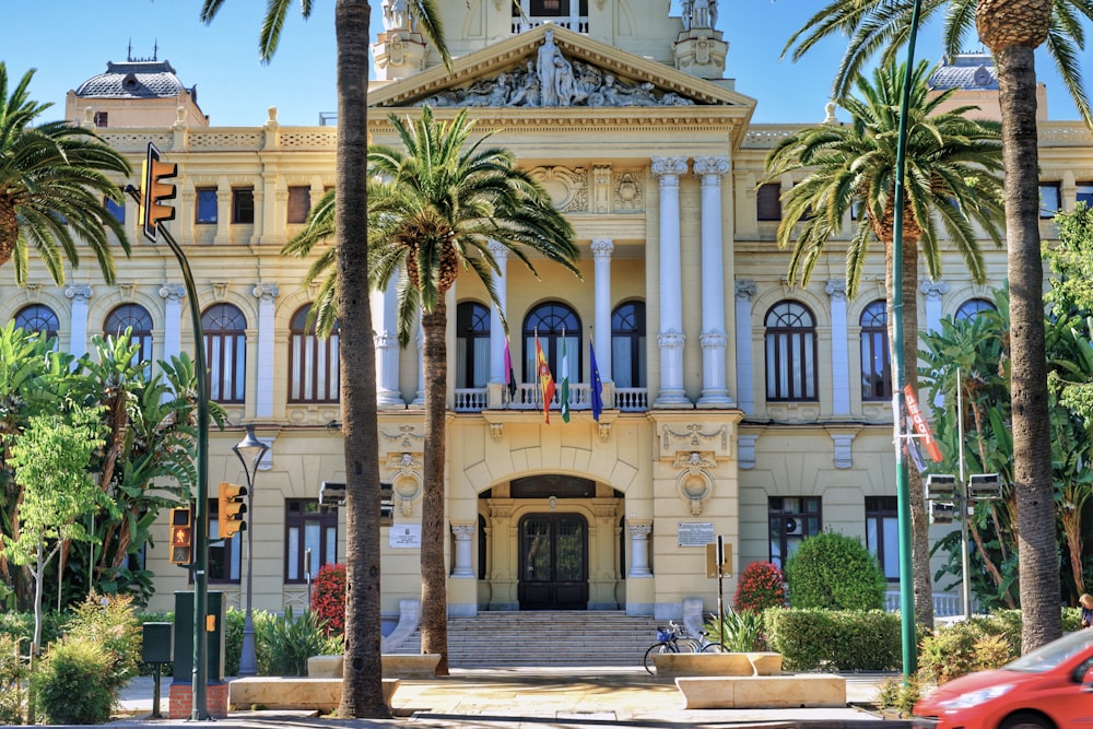 a large building with palm trees in front of it