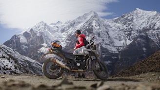 a person sitting on a motorcycle in Himalayas near Manali