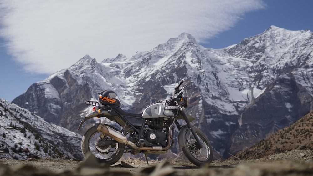 a motorcycle parked on the side of a mountain