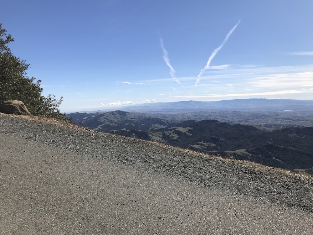 a view of the mountains from the top of a hill