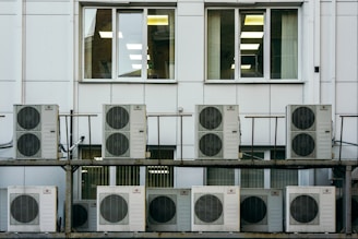 Close-up of a technician performing preventive maintenance on an air conditioning system.