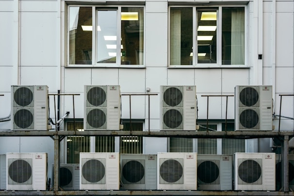 Technician inspecting HVAC equipment in a commercial building