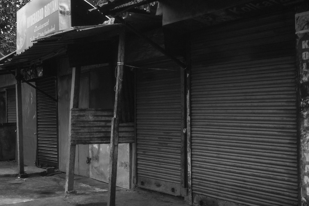 a black and white photo of a building with shutters