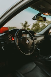 the interior of a car with a steering wheel and dashboard