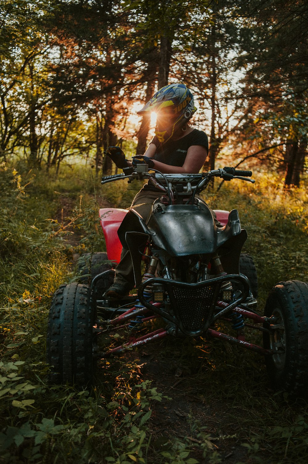 a person riding an atv in the woods