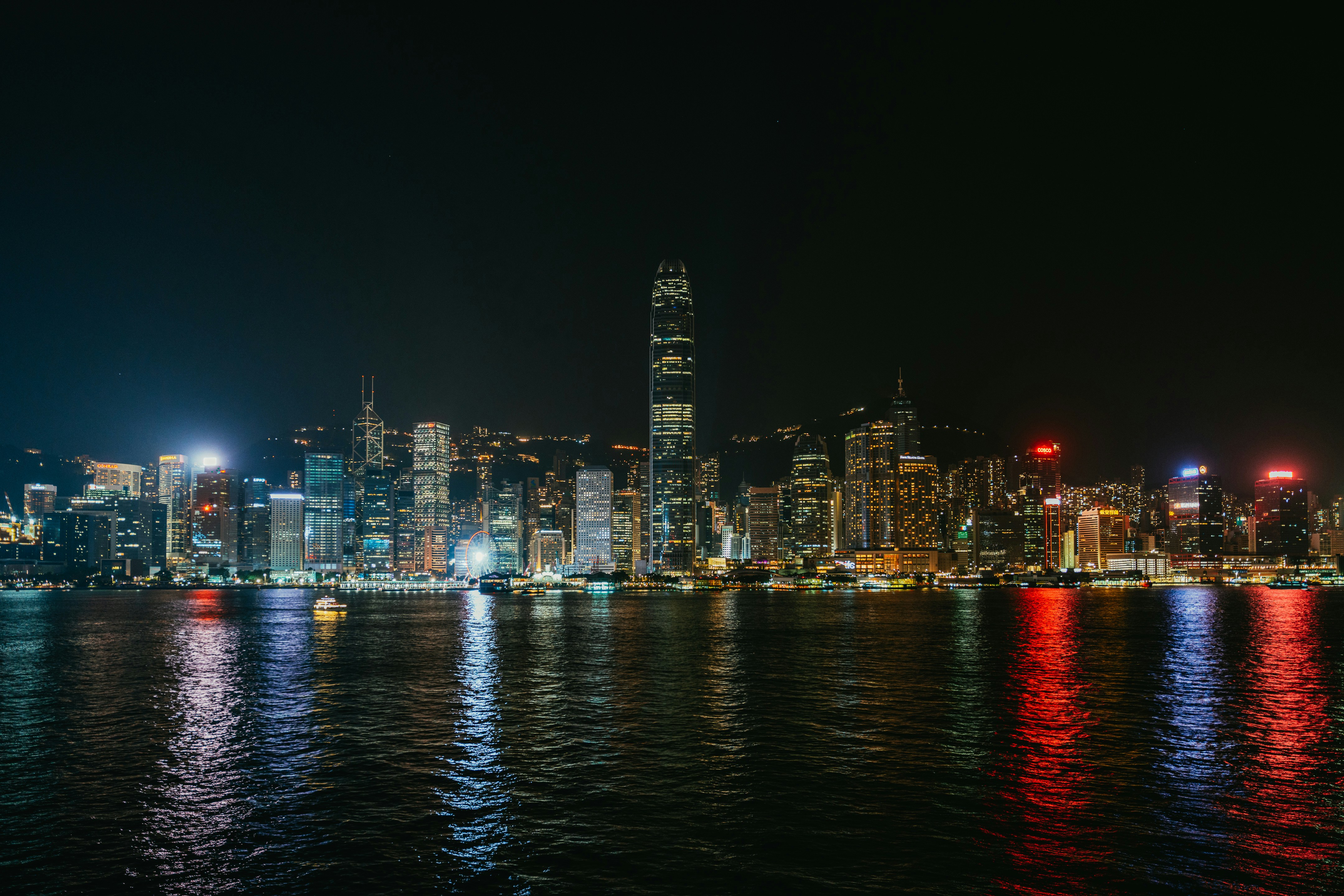 a city skyline is lit up at night, 