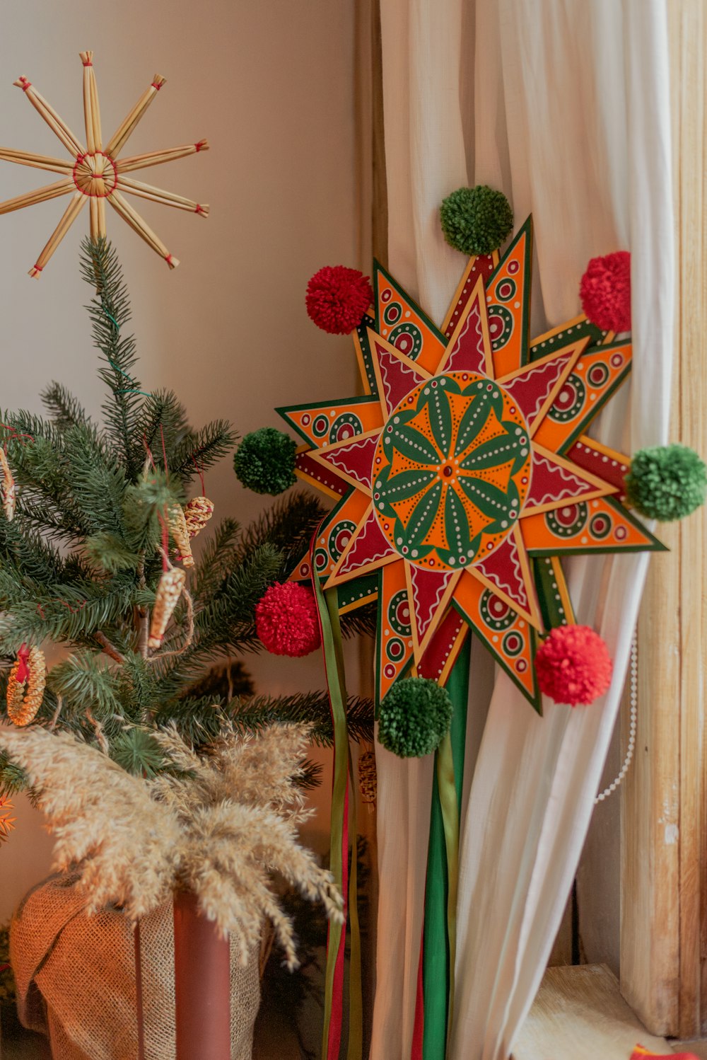 a decorated star next to a christmas tree