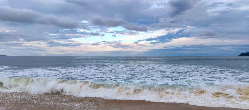 a beach with waves coming in to shore