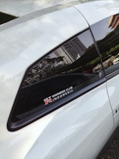 A smiling salesperson handing car keys to a happy customer in Jakarta.