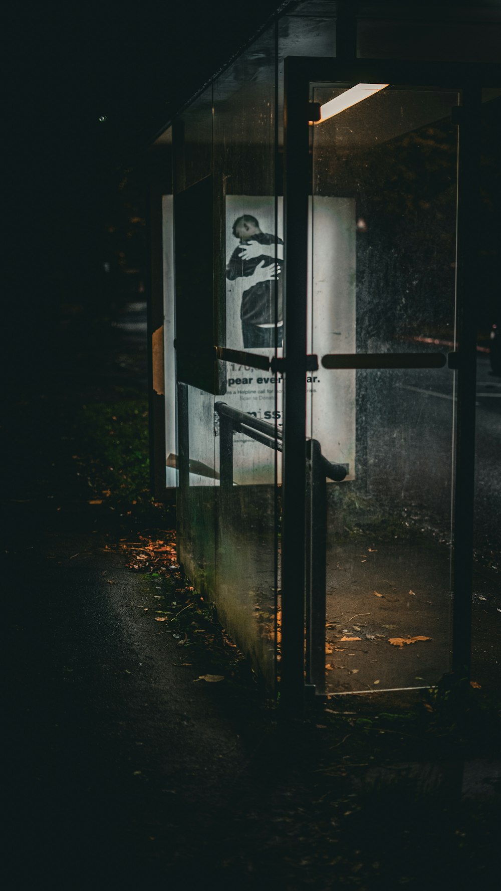 a bus stop with a poster on the side of it