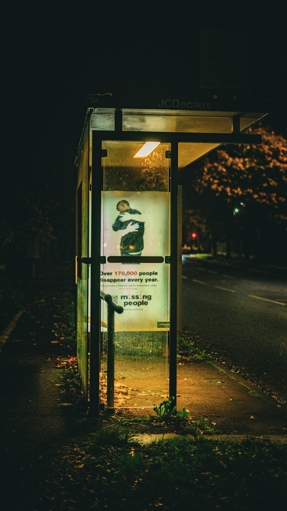 a bus stop sitting on the side of a road