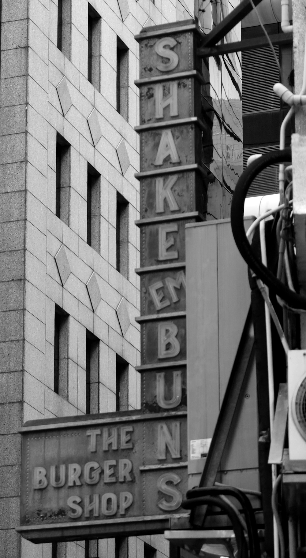 a black and white photo of a burger shop sign