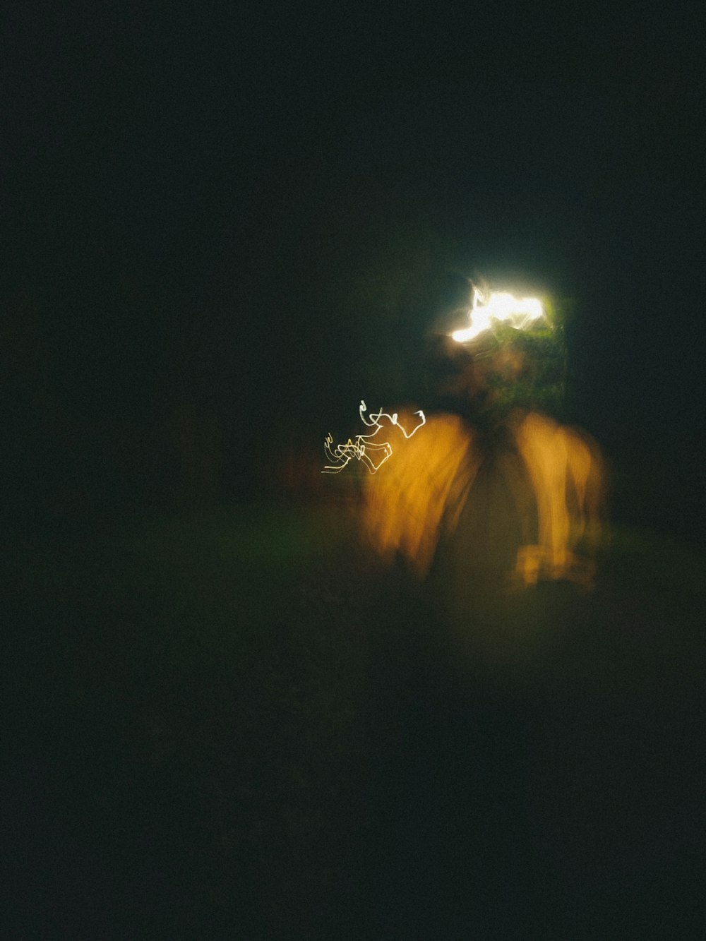 a blurry photo of a person walking in the dark