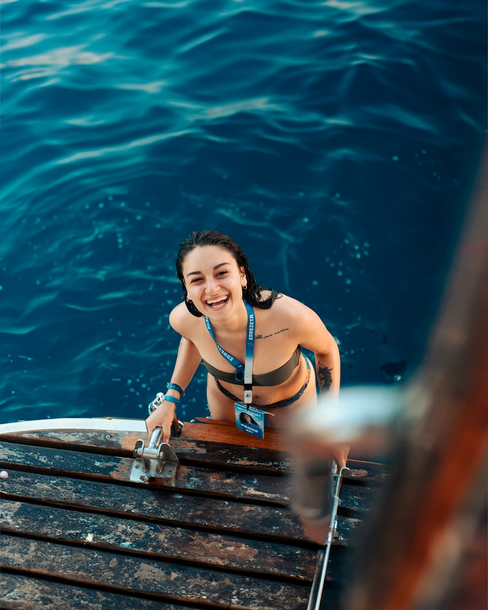 a woman in a bikini sitting on a boat
