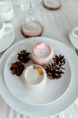 a white plate topped with cookies next to a cup of coffee