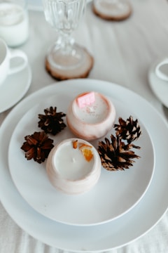 a white plate topped with cookies next to a cup of coffee