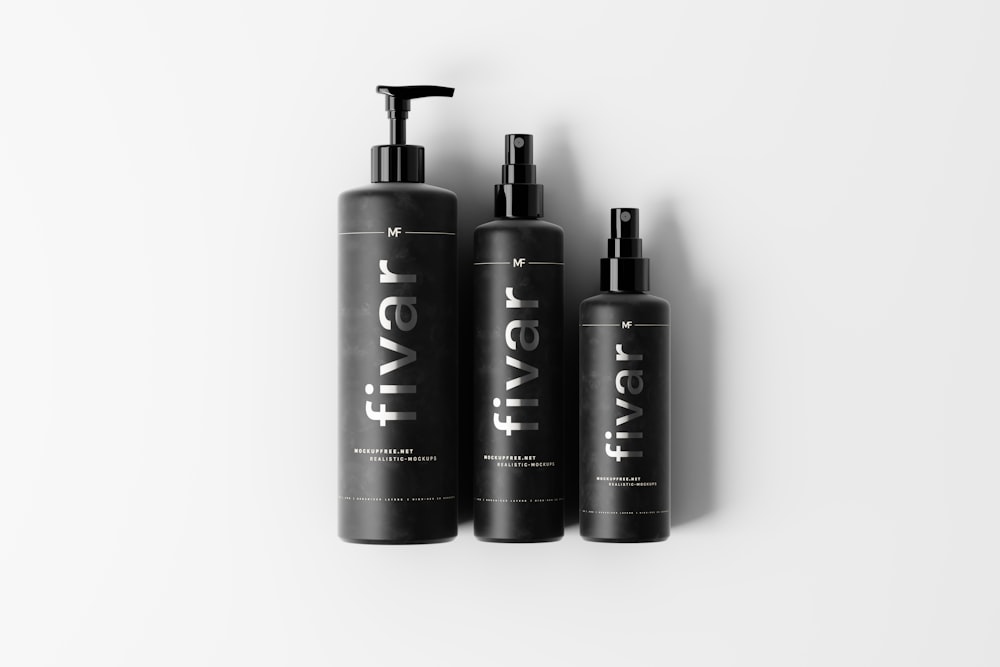 three bottles of hair products on a white background