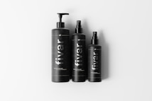 Three black bottles each with a dispenser pump or spray top, labeled with the brand name 'fivar'. They are arranged side by side on a plain white background.