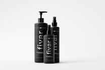 Three black bottles of varying sizes with minimalist design are arranged together. Each bottle features the brand name 'fivar' vertically printed in white. The bottles have different types of dispensers, indicating they may be for different types of products.