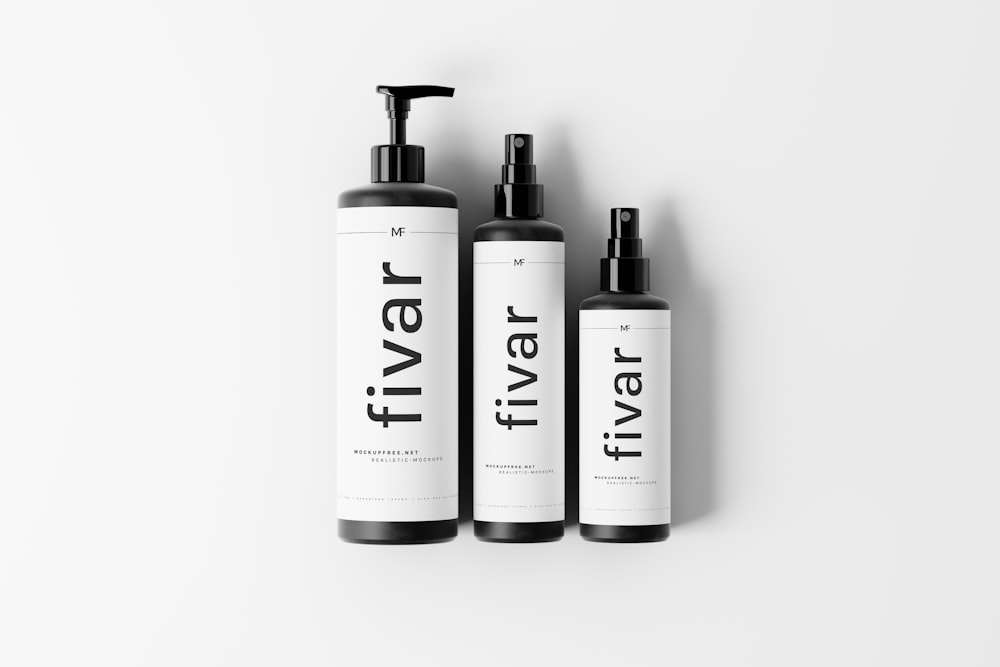 three bottles of travel shampoo on a white background