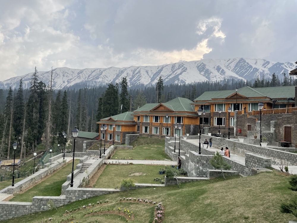 a group of buildings sitting on top of a lush green hillside