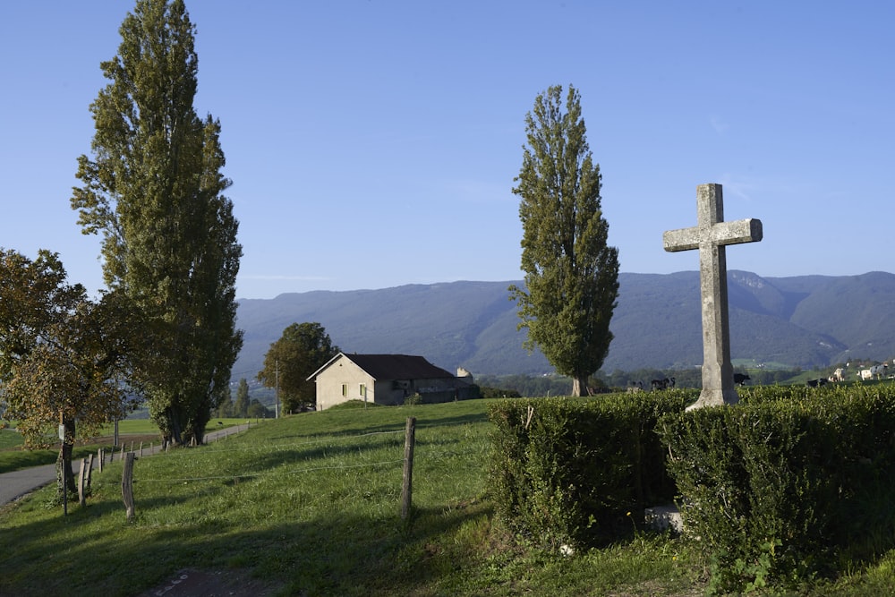 a cross in the middle of a grassy field