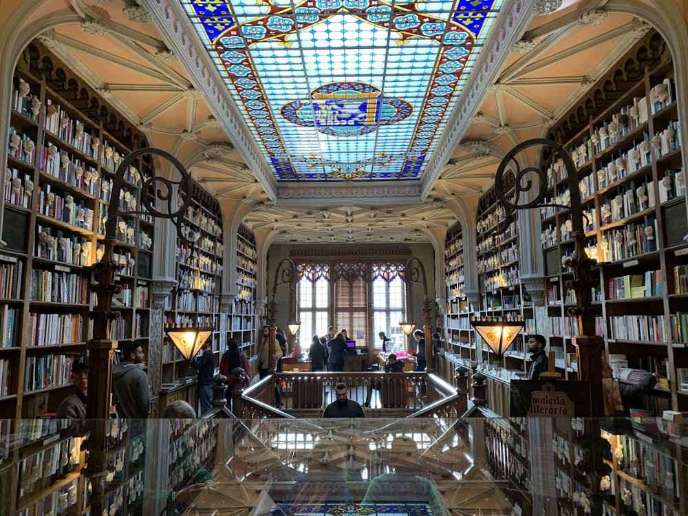 a library filled with lots of books and a skylight