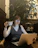 Happy woman with glasses working on a laptop in cozy home office.