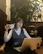 Happy woman with glasses working on a laptop in cozy home office.