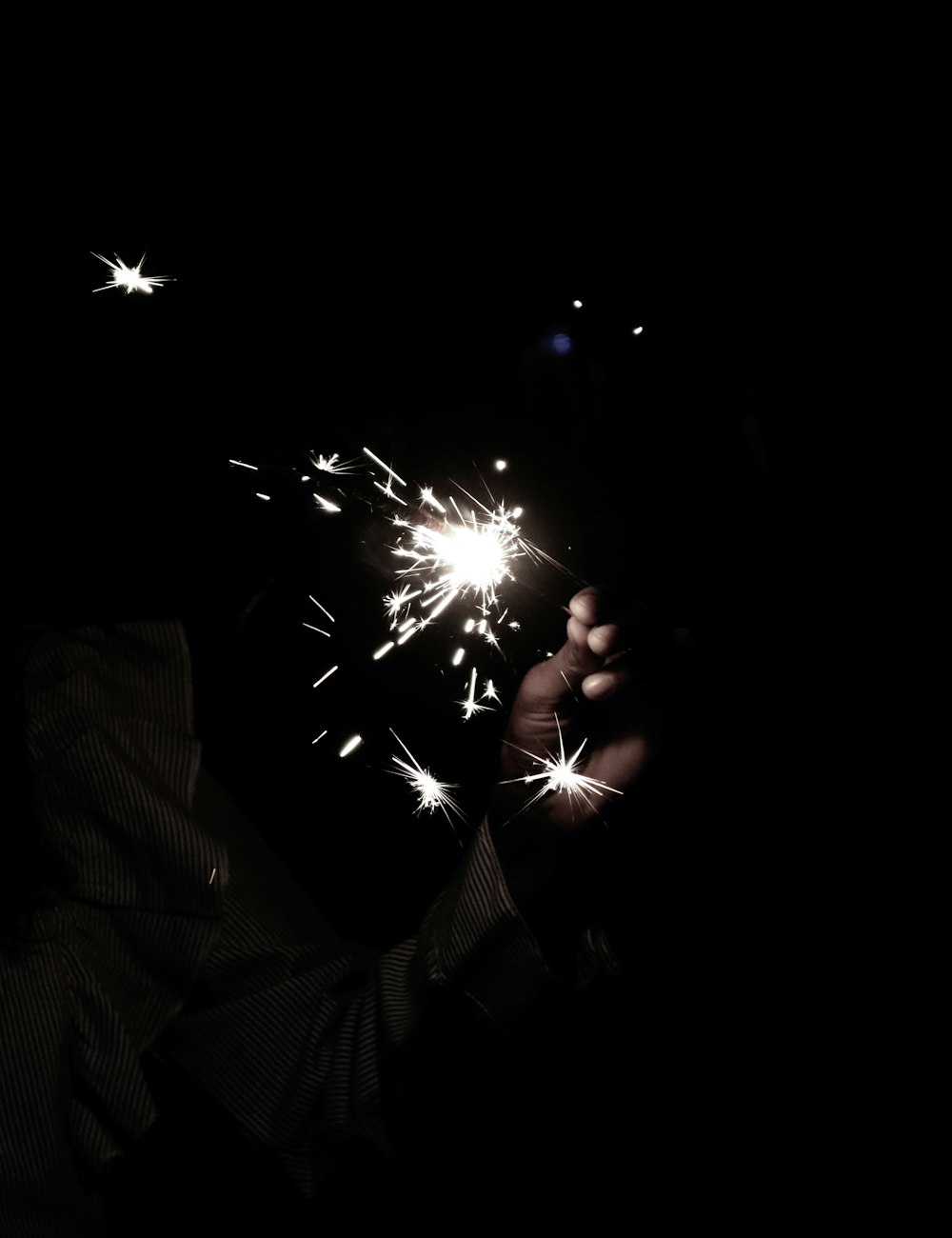 a person is holding a sparkler in their hand