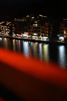 Nighttime cityscape of Veracruz illuminated by red and black lights.