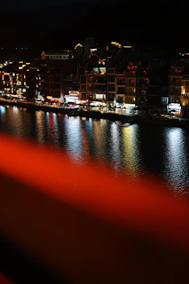 Nighttime cityscape of Veracruz illuminated by red and black lights.