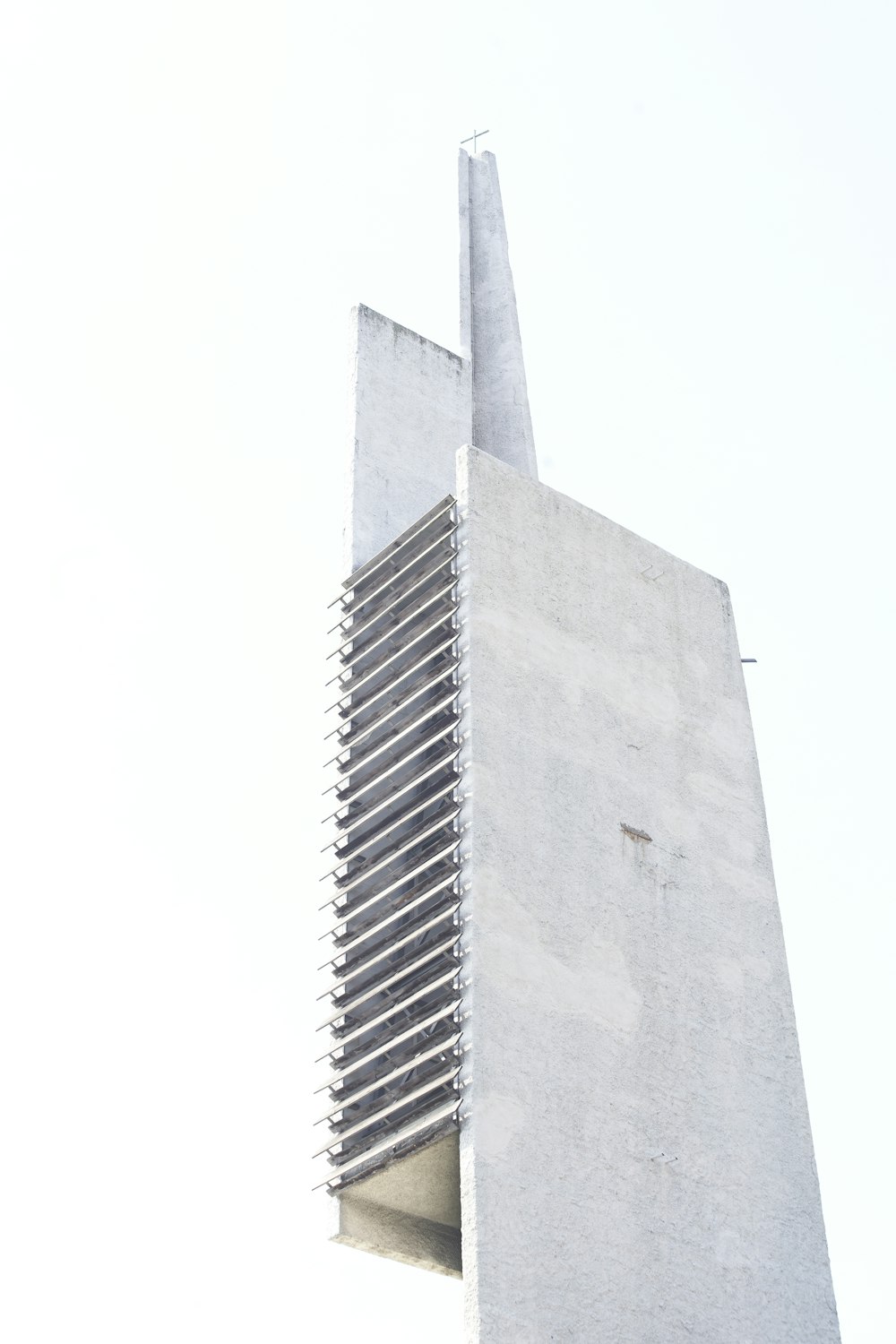 a tall white building with a sky background