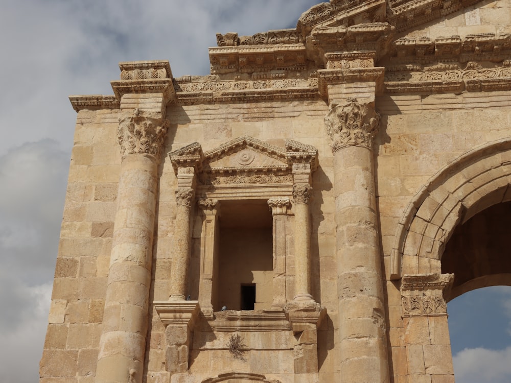 a large stone building with a clock on it's side