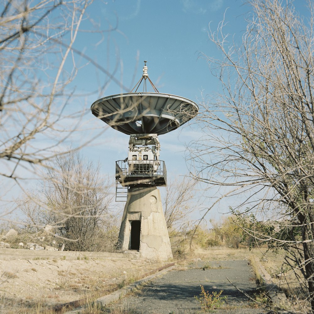 a satellite dish sitting on top of a cement structure