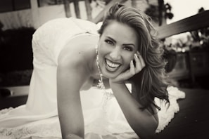 An elegant woman leaning forward with a warm, welcoming expression