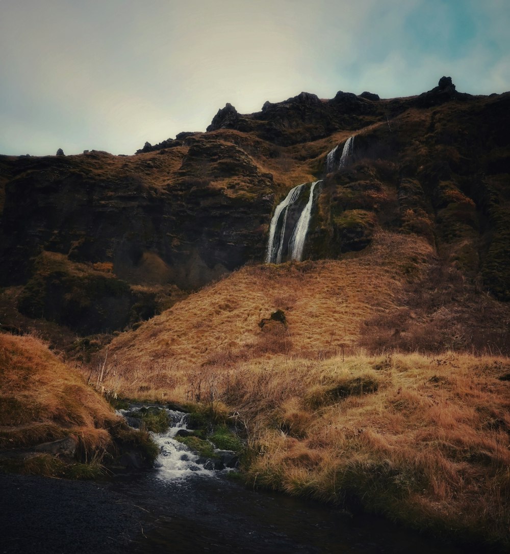 a small waterfall on the side of a mountain