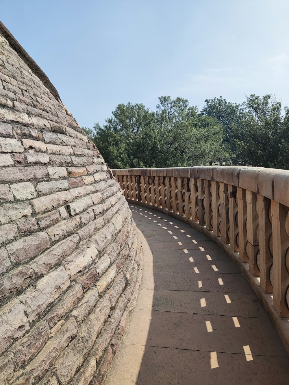 a stone bridge with a curved road going over it